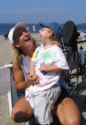 Adult holding a smiling Alex