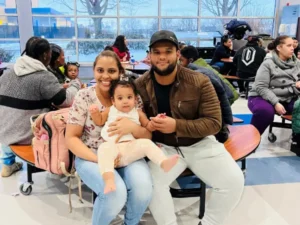 Room with multiple families sitting with their very young children.
