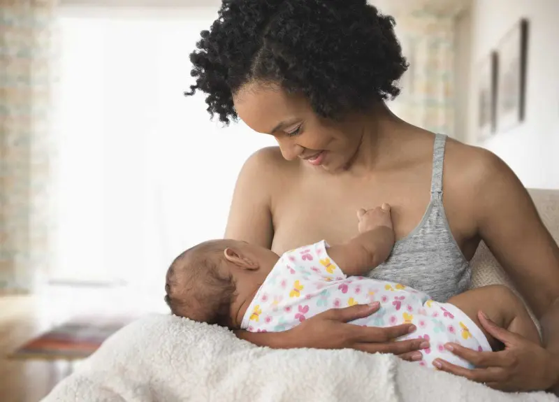 Infant with mother breastfeading.